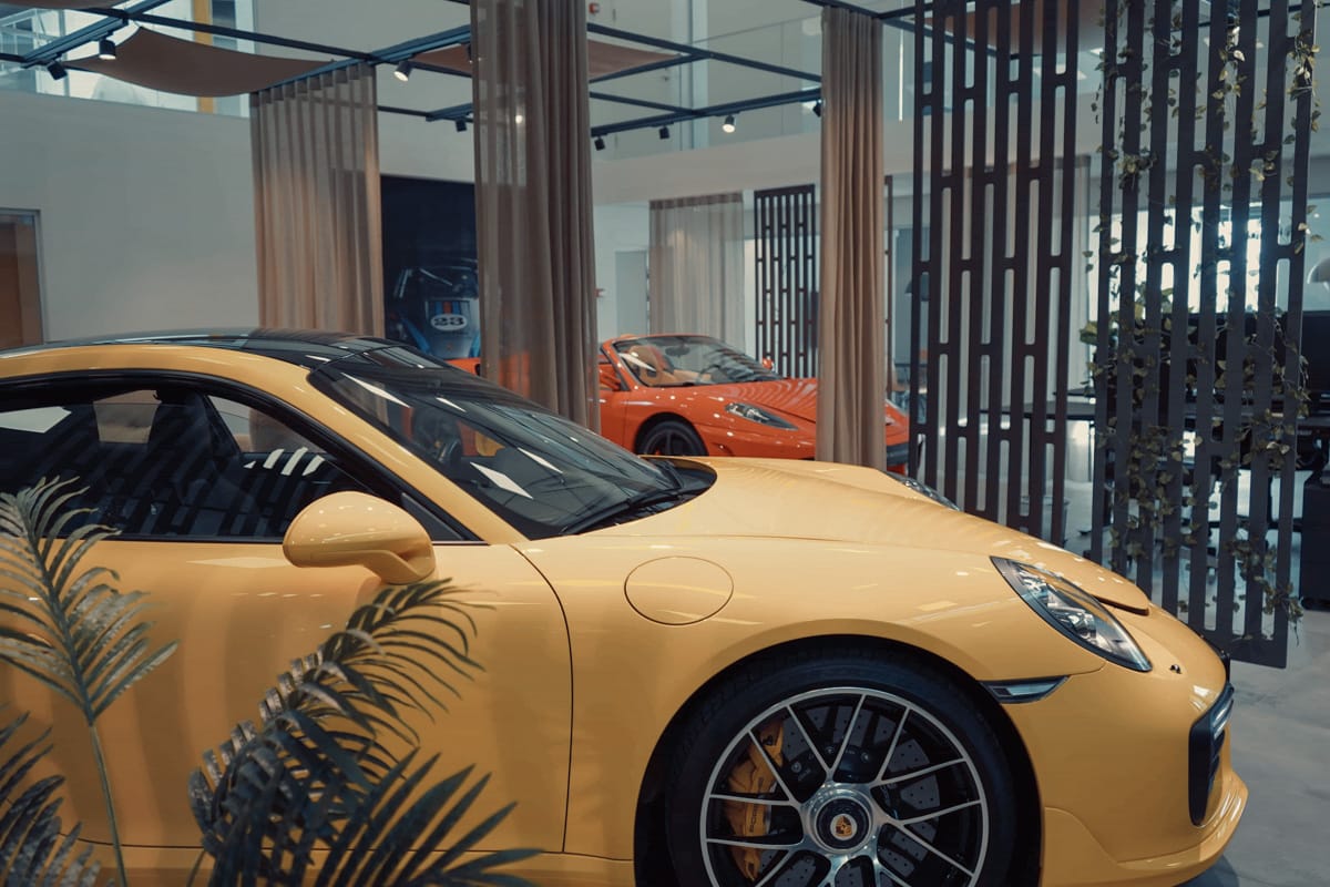 a yellow sports car in a showroom