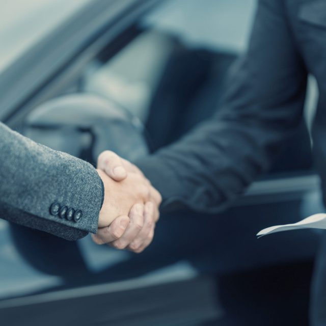 a close-up of a man shaking hands with another man